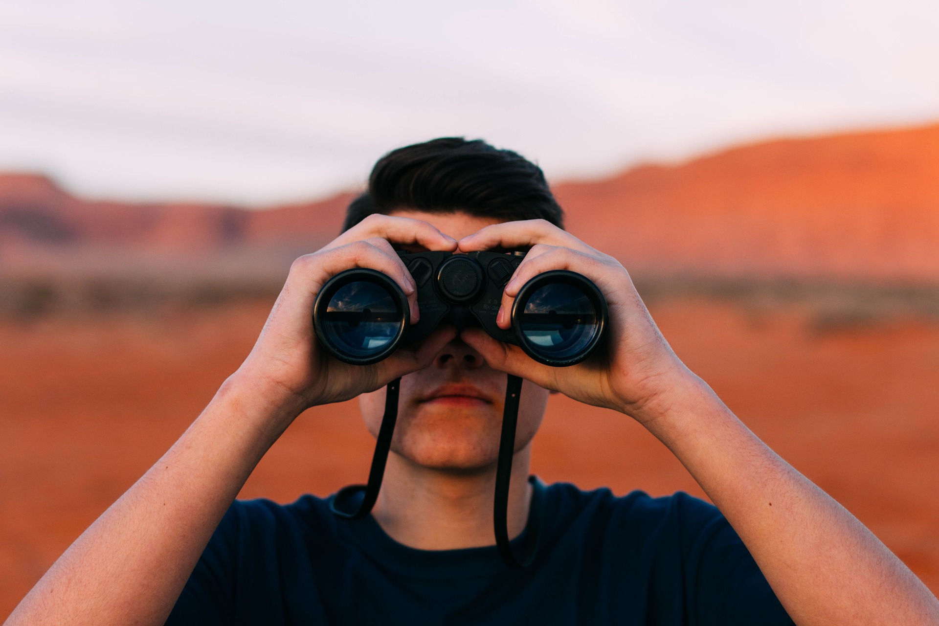 Man with binoculars searching.