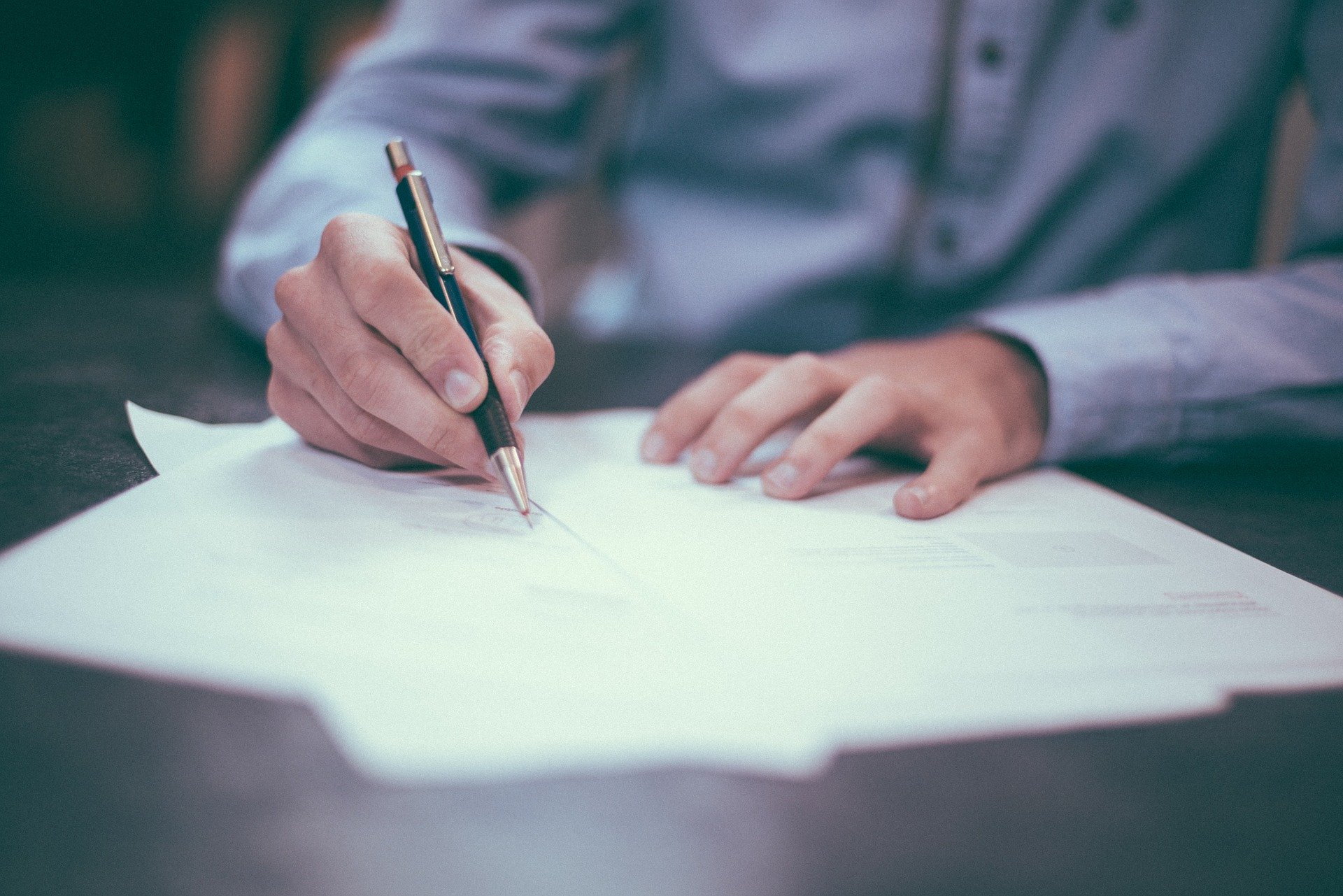 Man signing a real estate contract.